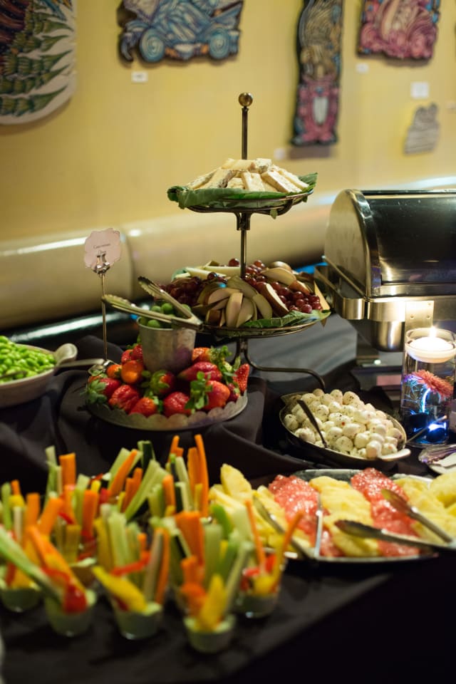 Colorful fruit and vegetable platters at Love Bomb 2017 event, featuring strawberries, celery, and assorted snacks, highlighting community engagement and support for My Voice Music nonprofit.
